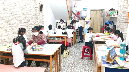 Students sharing completed classroom work